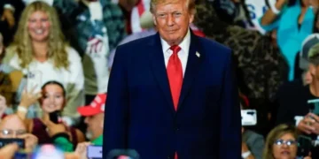 MAGA fan rushes back to Trump rally in hospital gown after having a seizure