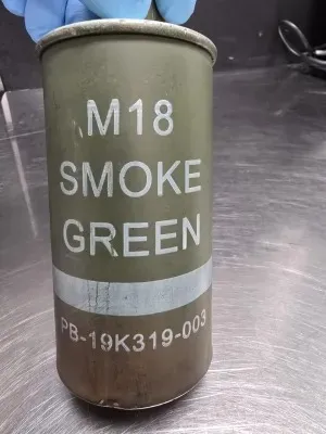A spent M18 green smoke grenade.