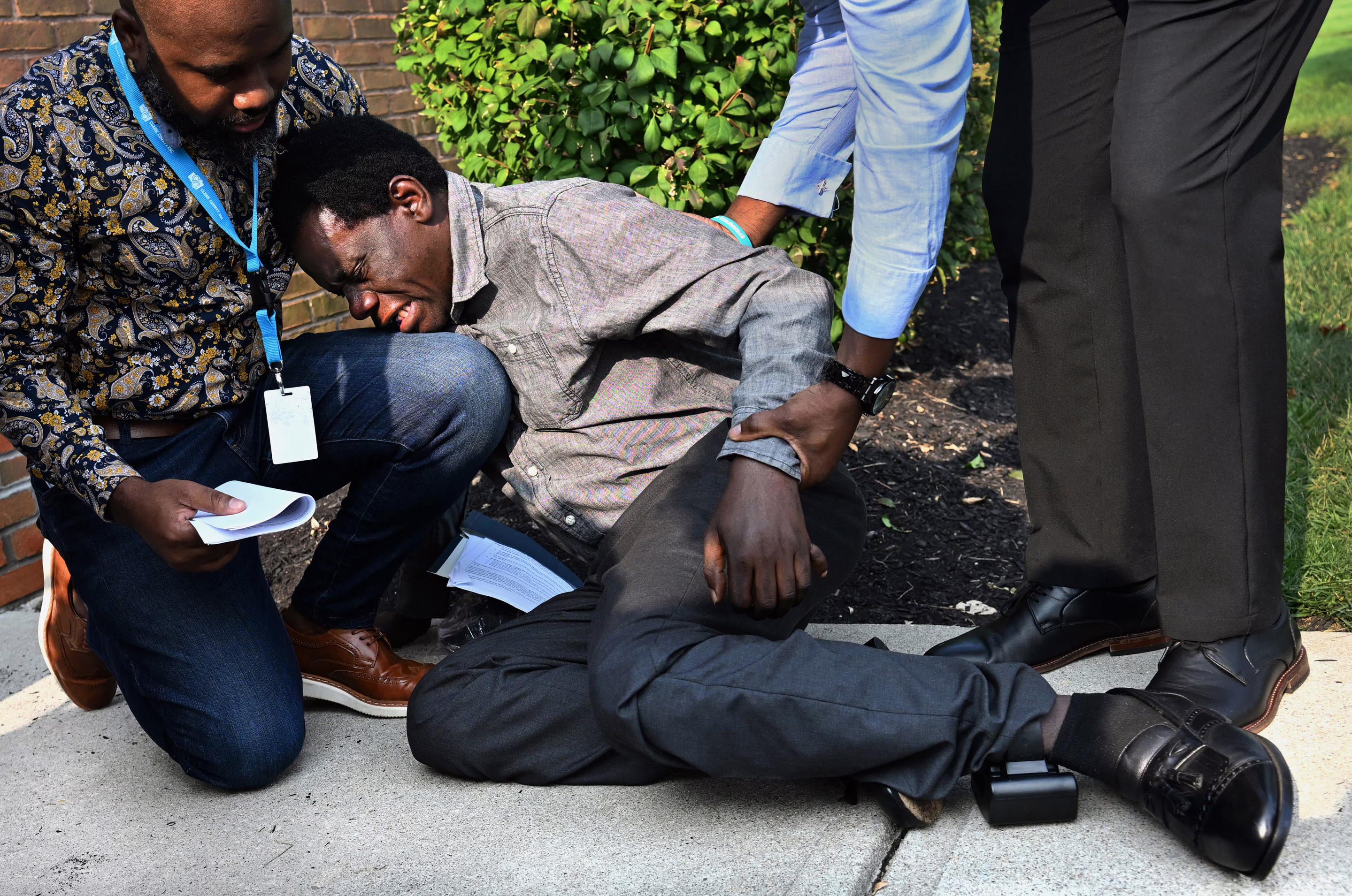 a man falls on the ground in distress