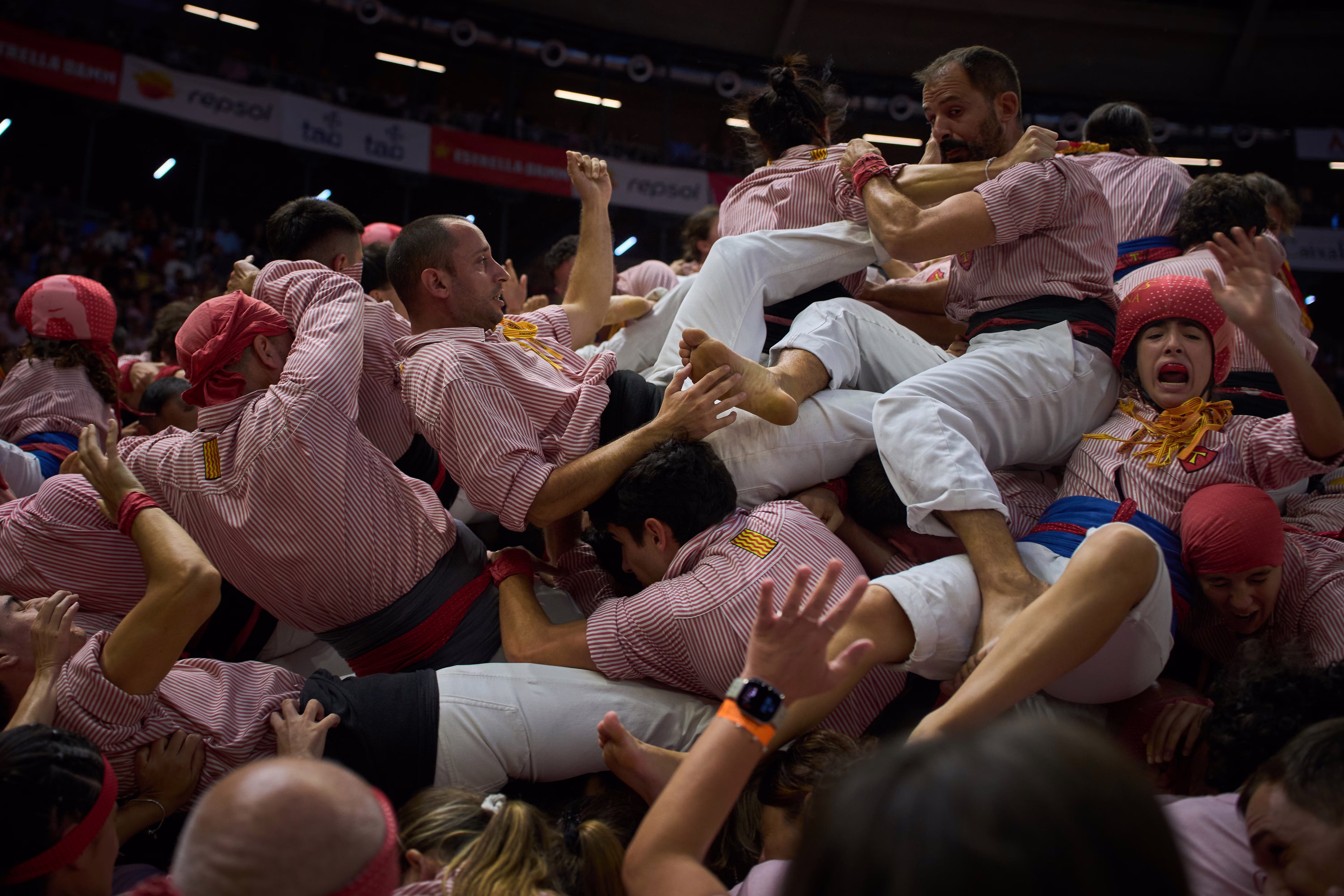 People fall after trying to form a human tower.