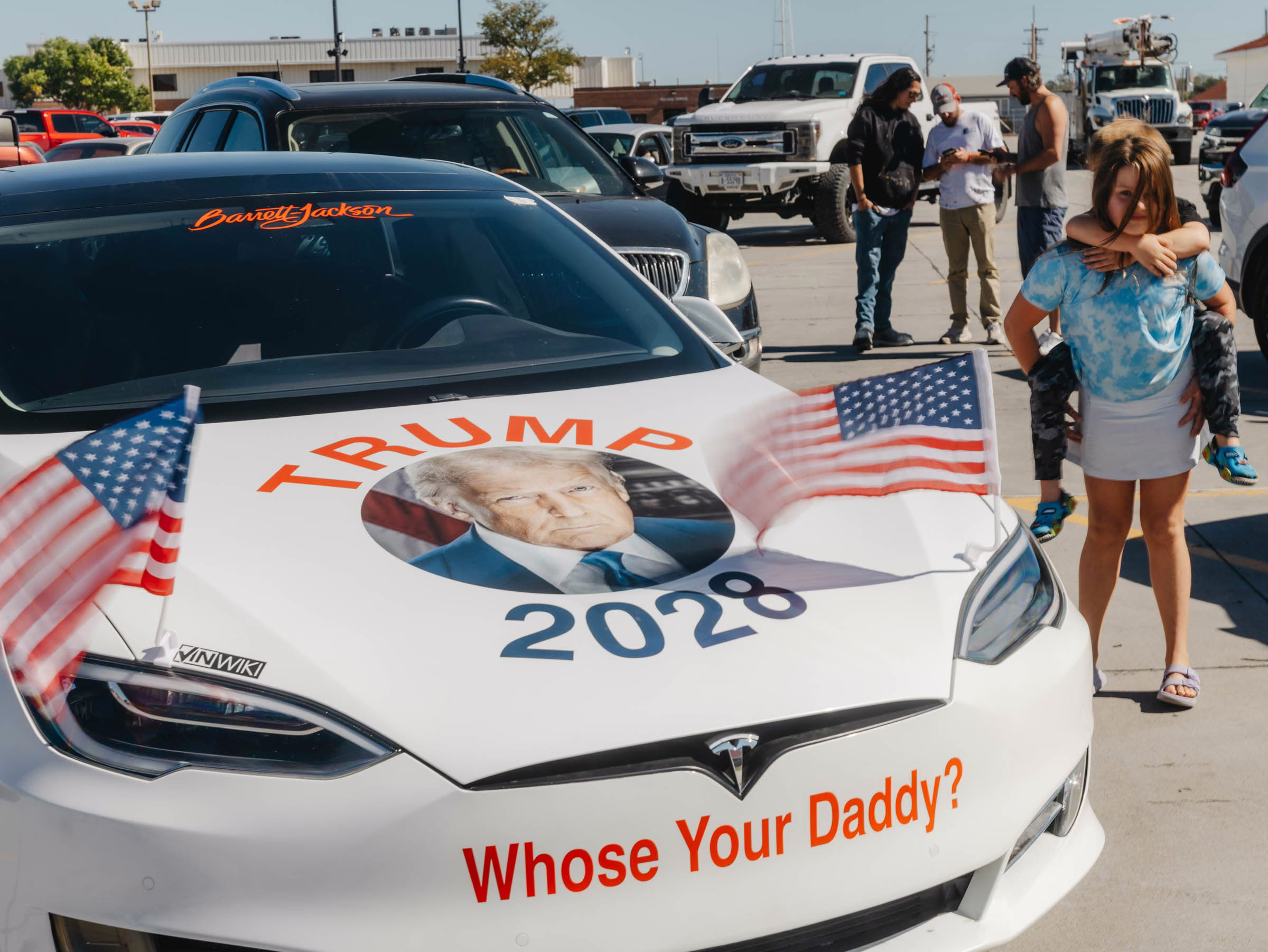 a car says Trump 2028 in a parking lot