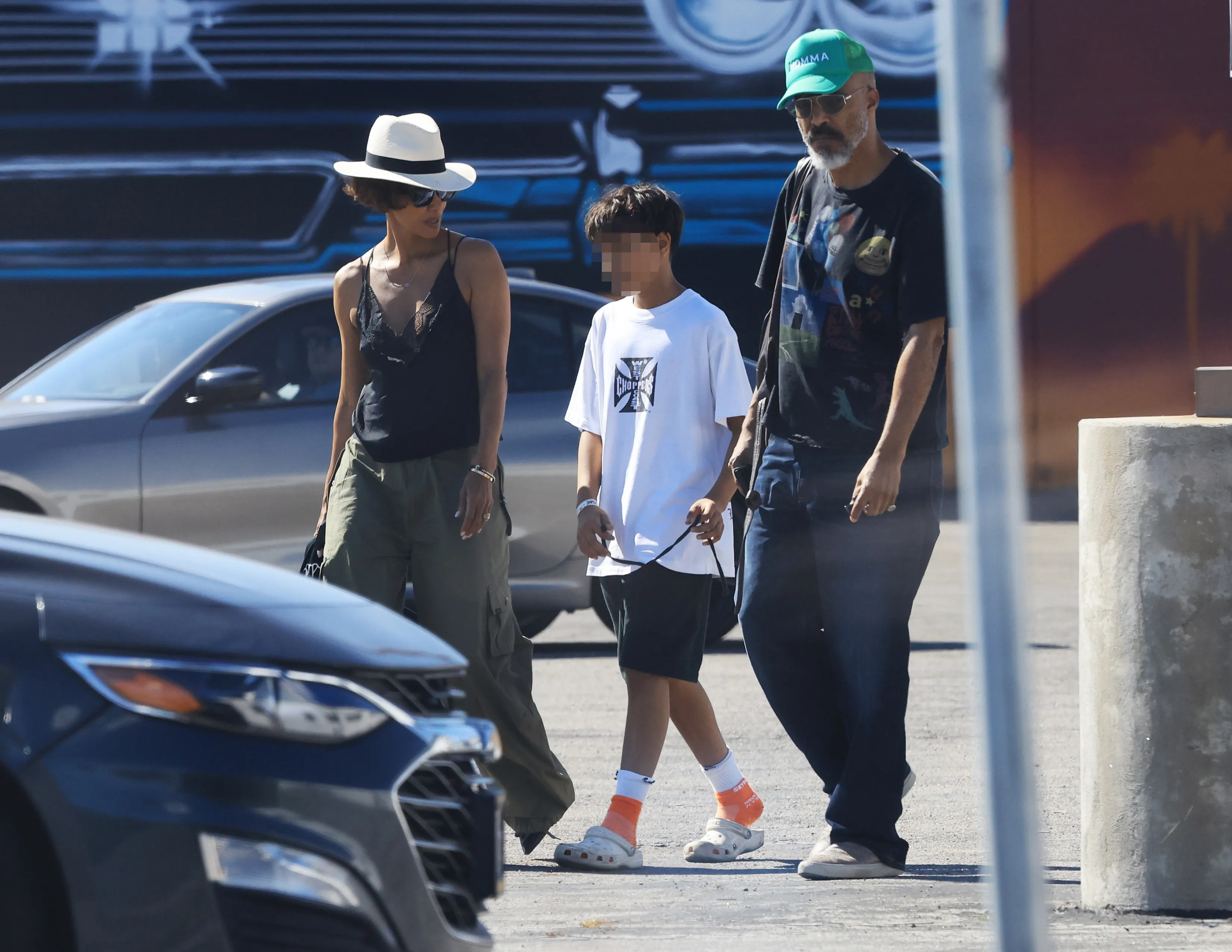Halle Berry, Van Hunt, and son Maceo Robert Martinez walking together outdoors.