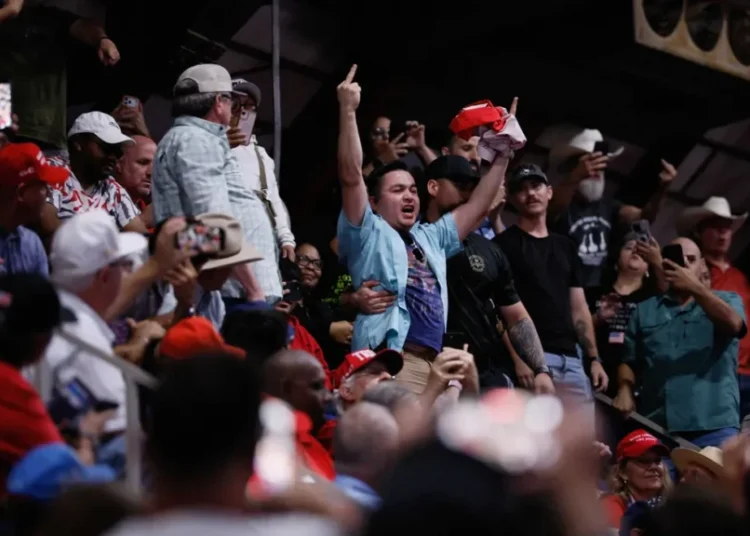 MAGA fan assaults Trump protester on his way out the door at Texas rally