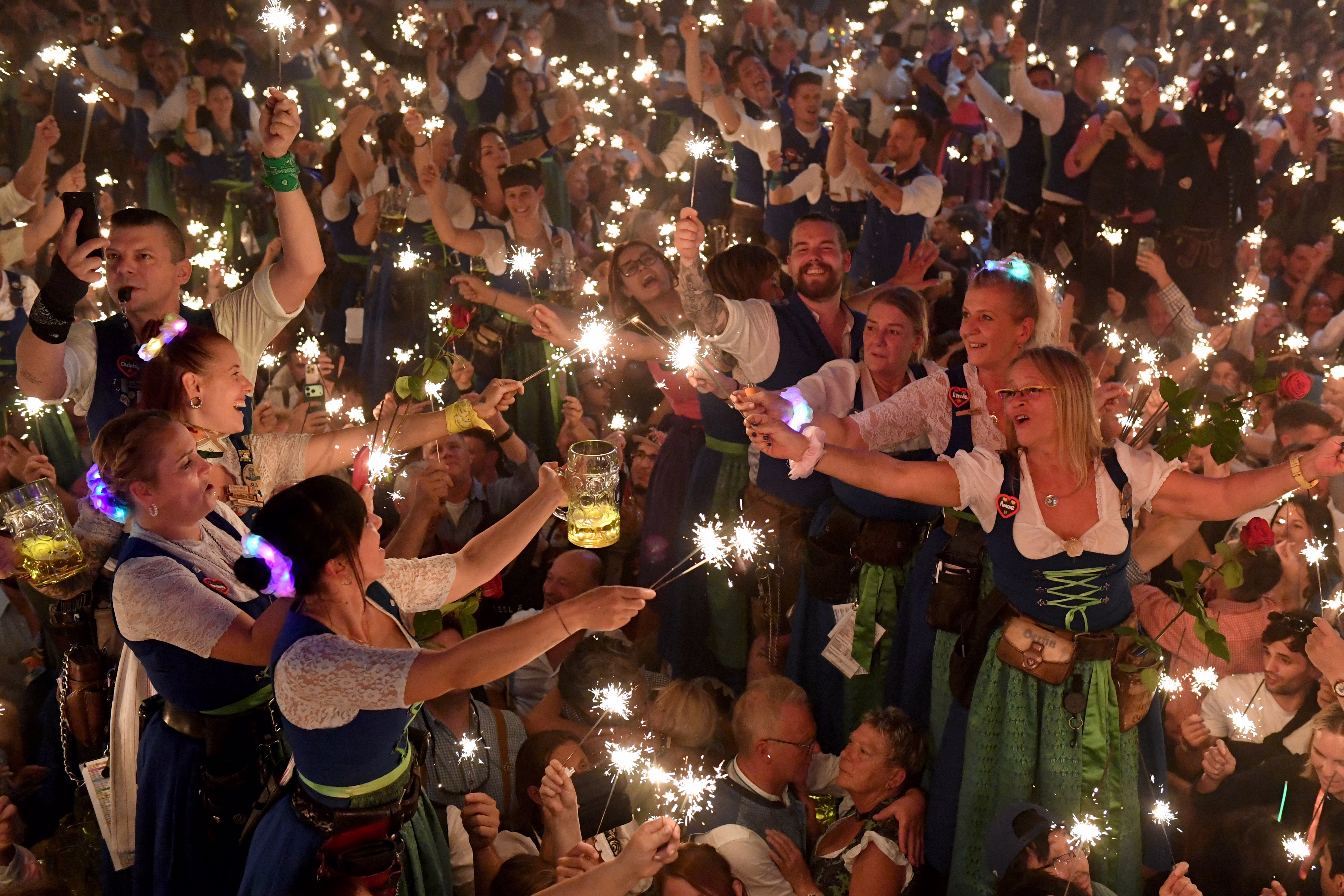 Waitstaff celebrate with sparklers at the Oktoberfest closing party.