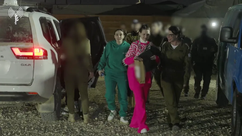 Released hostages Romi Gonen, Emily Damari, and Doron Steinbrecher are transferred to the IDF from the Red Cross.