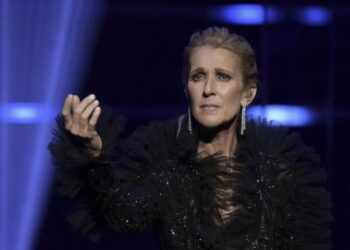 Céline Dion takes a tumble, but goes on