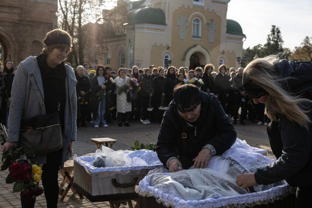 After Russian strike wipes out three families, Ukrainian town gathers to mourn