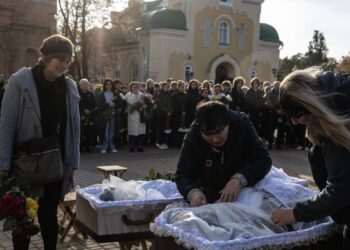 After Russian strike wipes out three families, Ukrainian town gathers to mourn