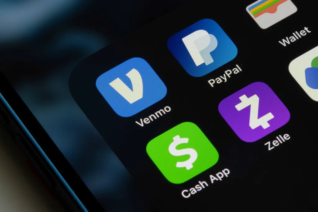 Venmo, PayPal, Cash App, and Zelle payment app icons displayed on a smartphone screen.