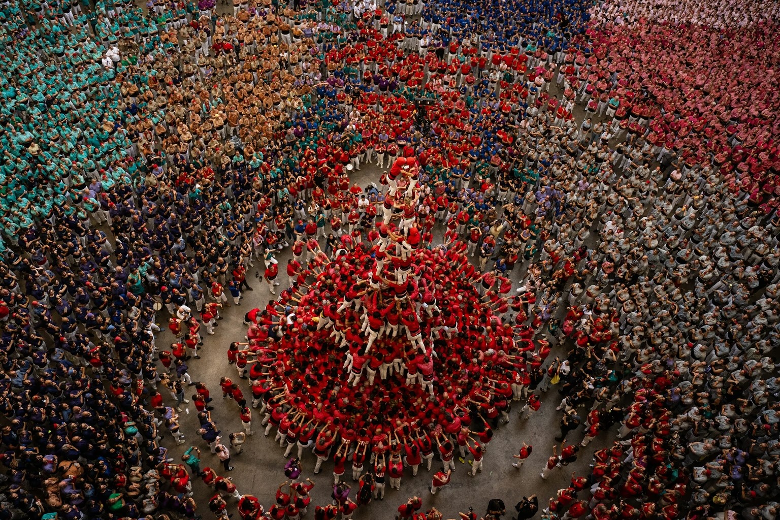 Members of Colla Joves Xiquets de Valls work on their human tower in Tarragona.