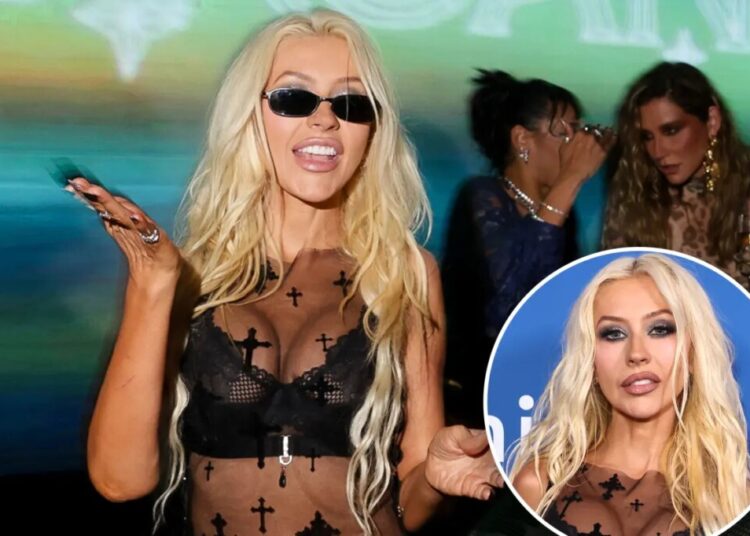 Iconic pop star, 45, stuns in sheer leather ensemble