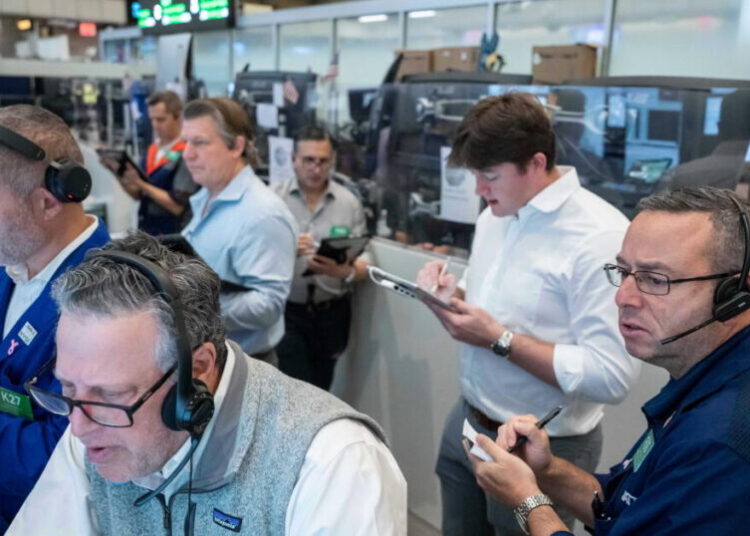 U.S. stocks hover near their latest record in mixed trading on Wall Street