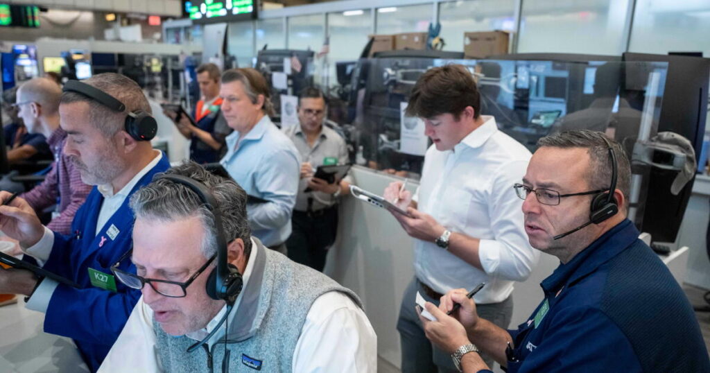 U.S. stocks hover near their latest record in mixed trading on Wall Street