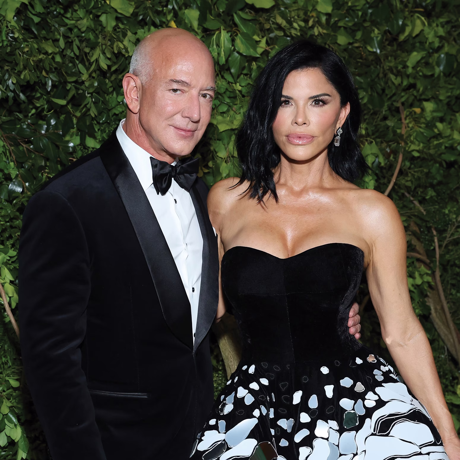 couple at event in formal wear with arms around each other