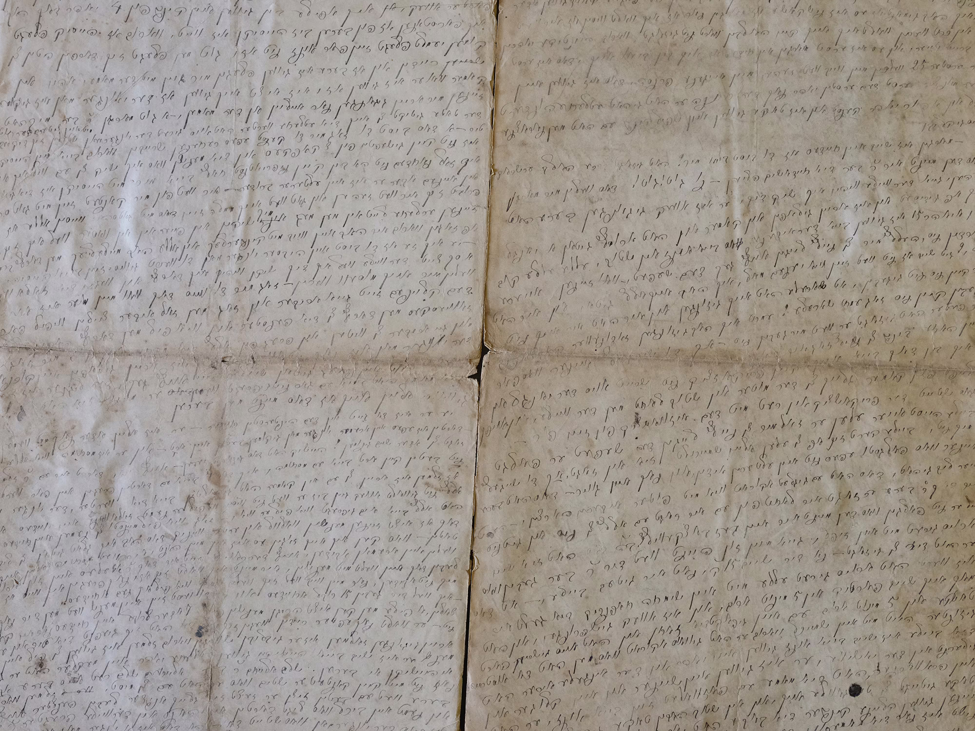 photo of multiple pages of manuscript covered with dense, faded handwriting