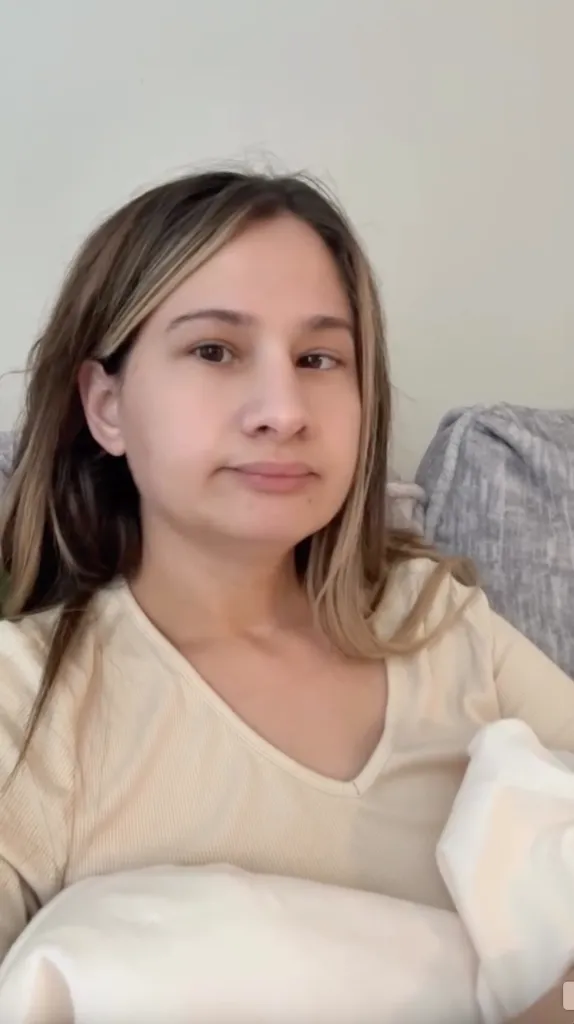Gypsy Rose Blanchard with light brown hair and a cream-colored top.