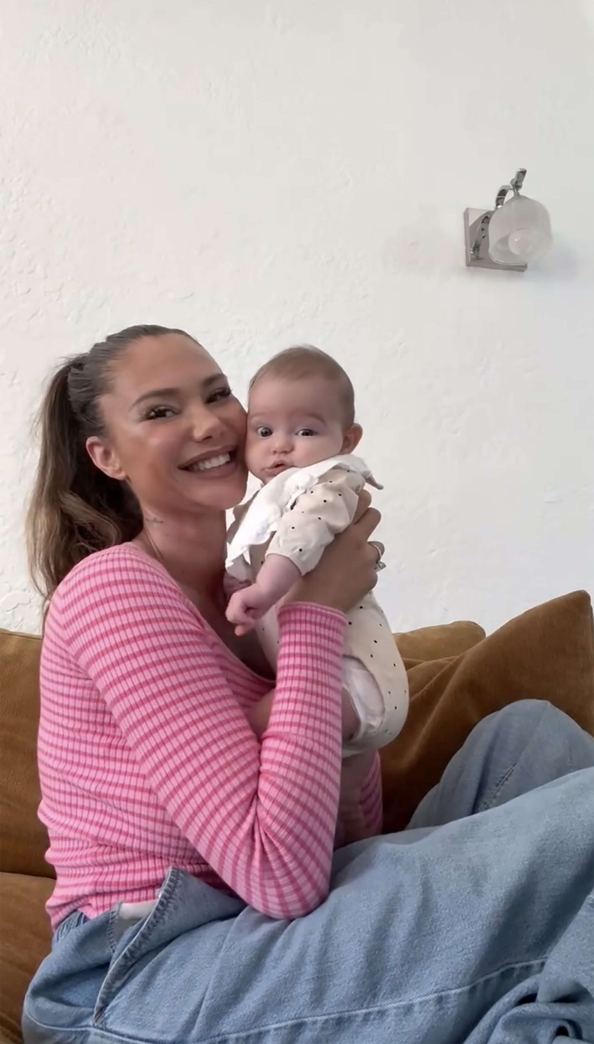 Sahara Ray holding a baby.