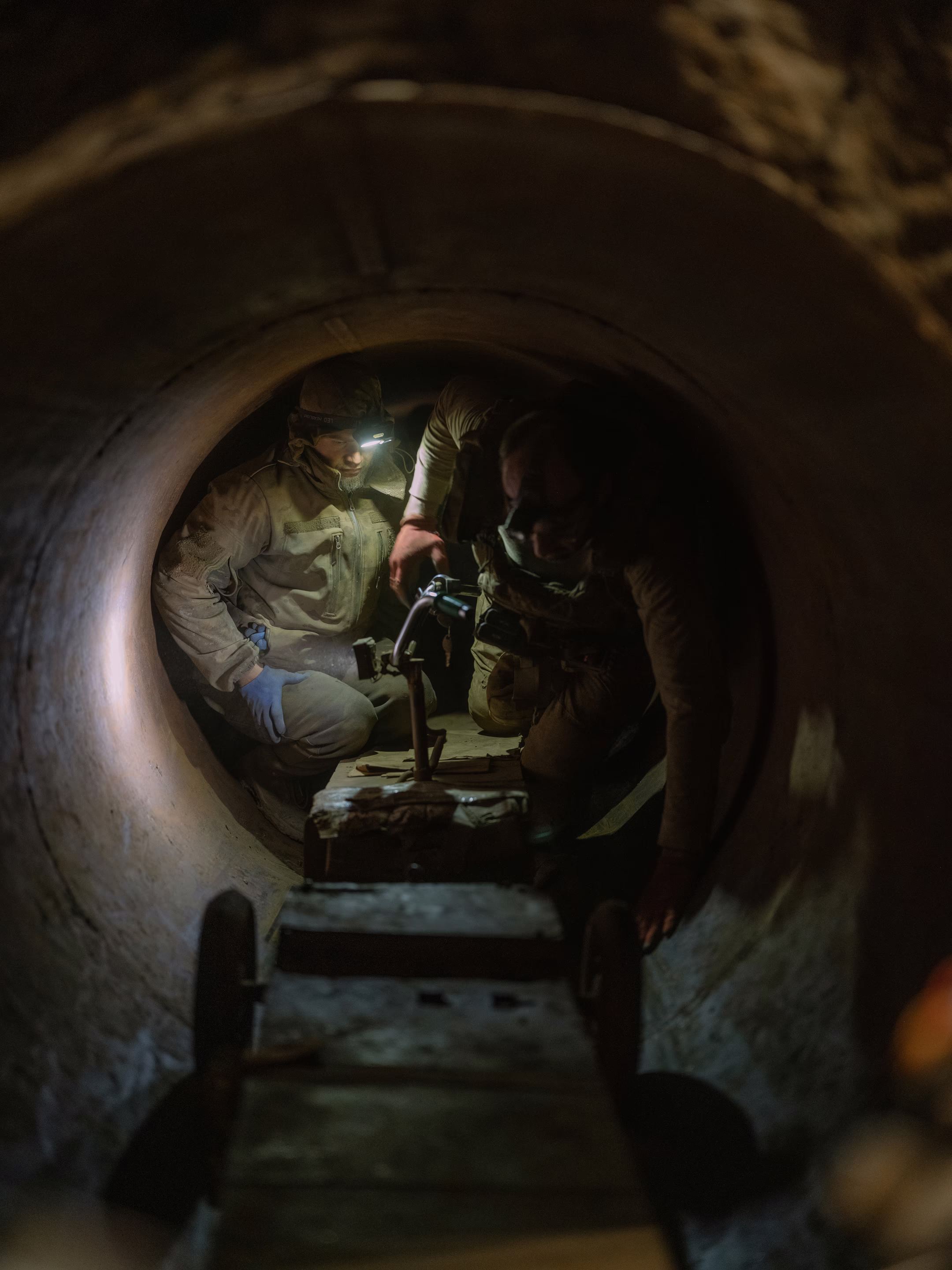 soldiers fix a scooter in a tunnel