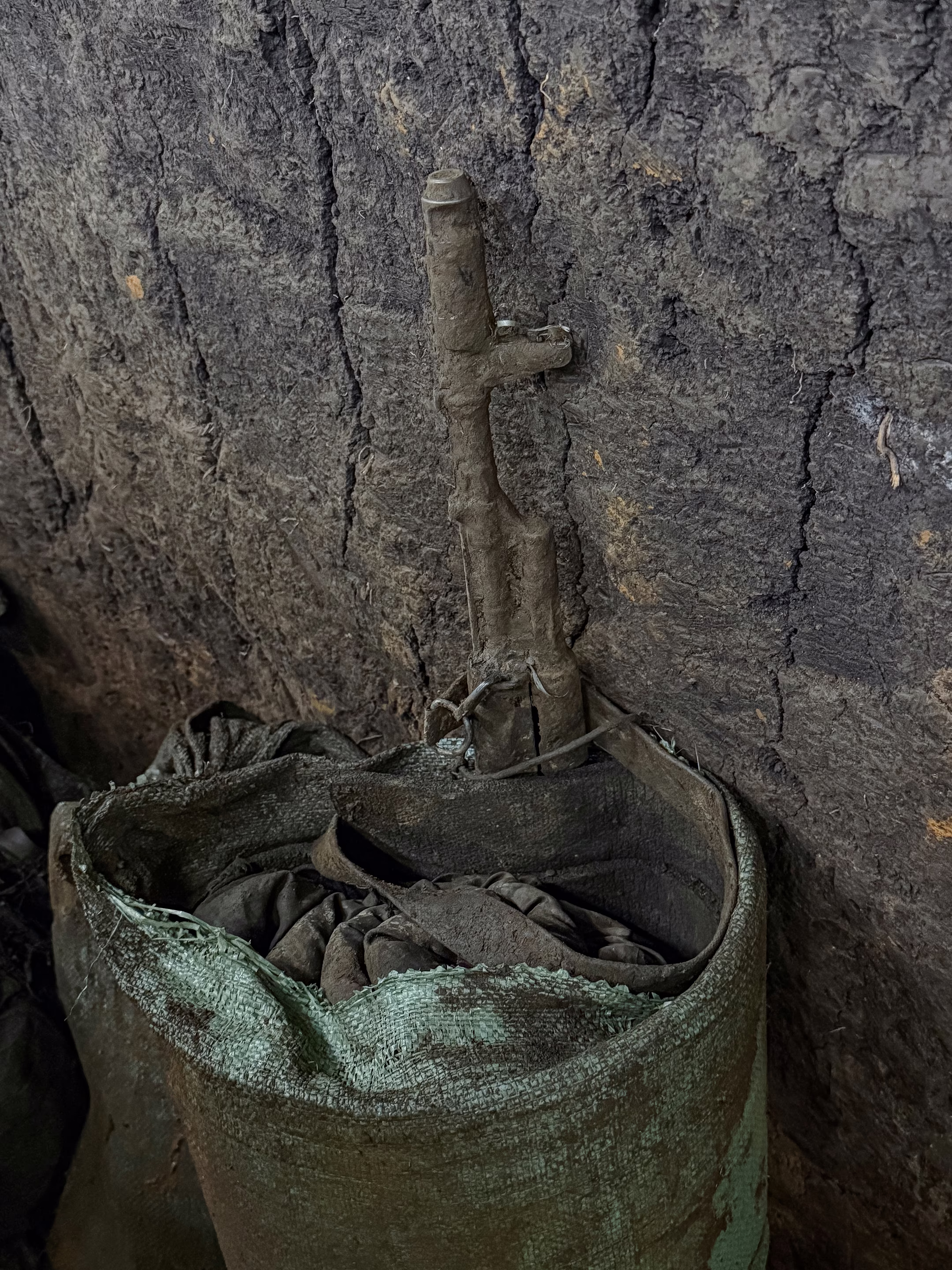a rifle and bag covered in mud