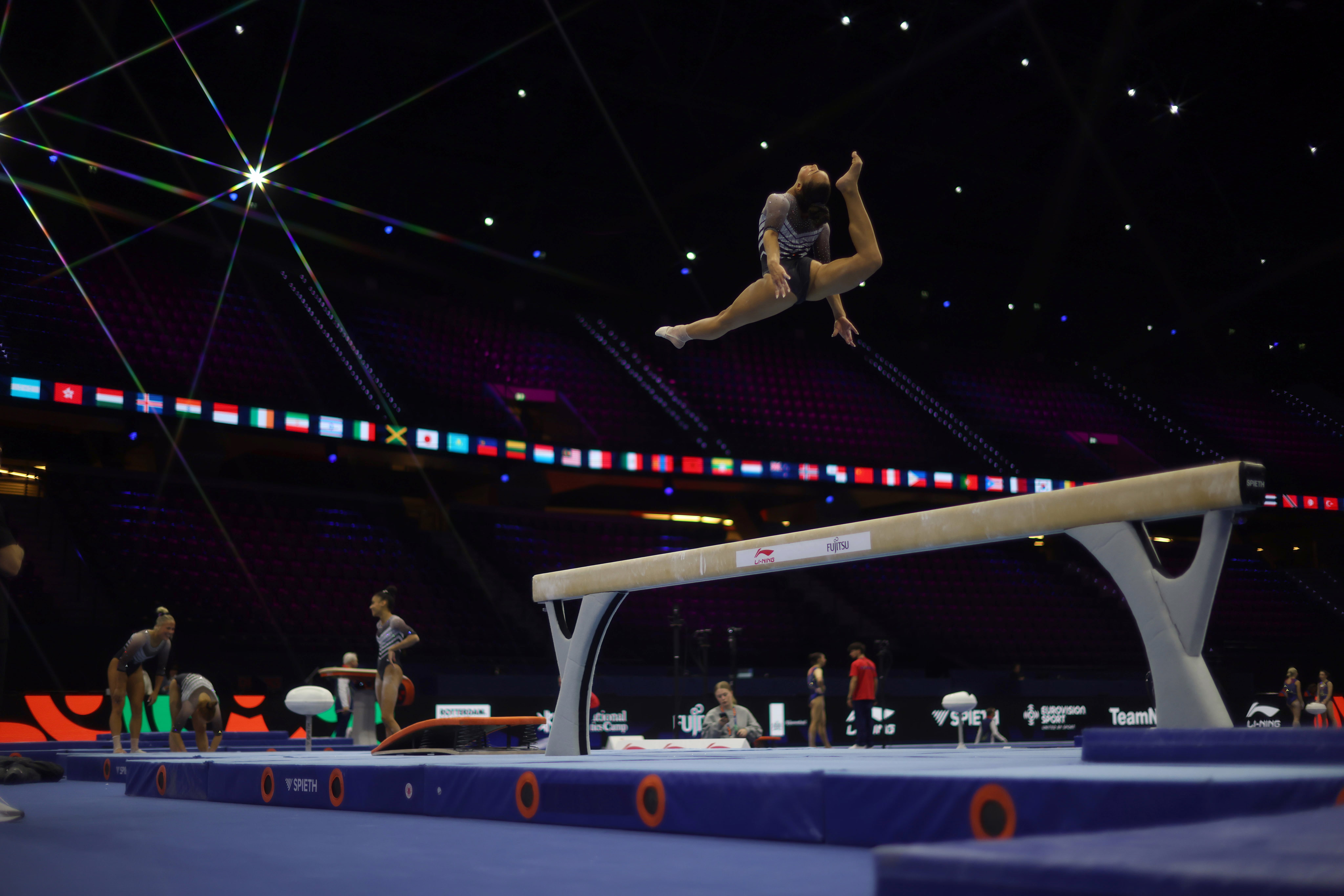 A gymnast practices their beam routine.