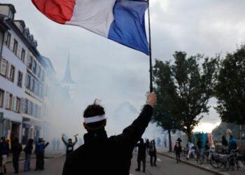 French police use tear gas and water cannons after some protests turn violent as shopkeepers board up storefronts across Paris