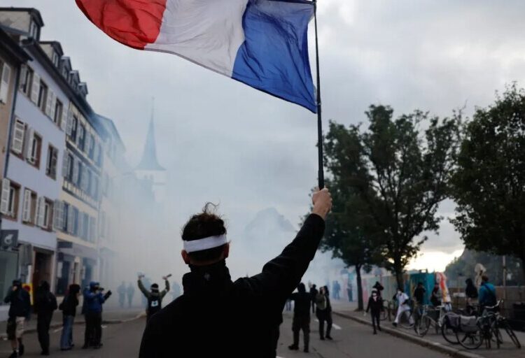 French police use tear gas and water cannons after some protests turn violent as shopkeepers board up storefronts across Paris