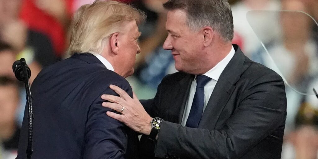 Audi CEO Gernot Döllner appears on stage with Trump at a Republican campaign rally to announce a new car factory in Georgia