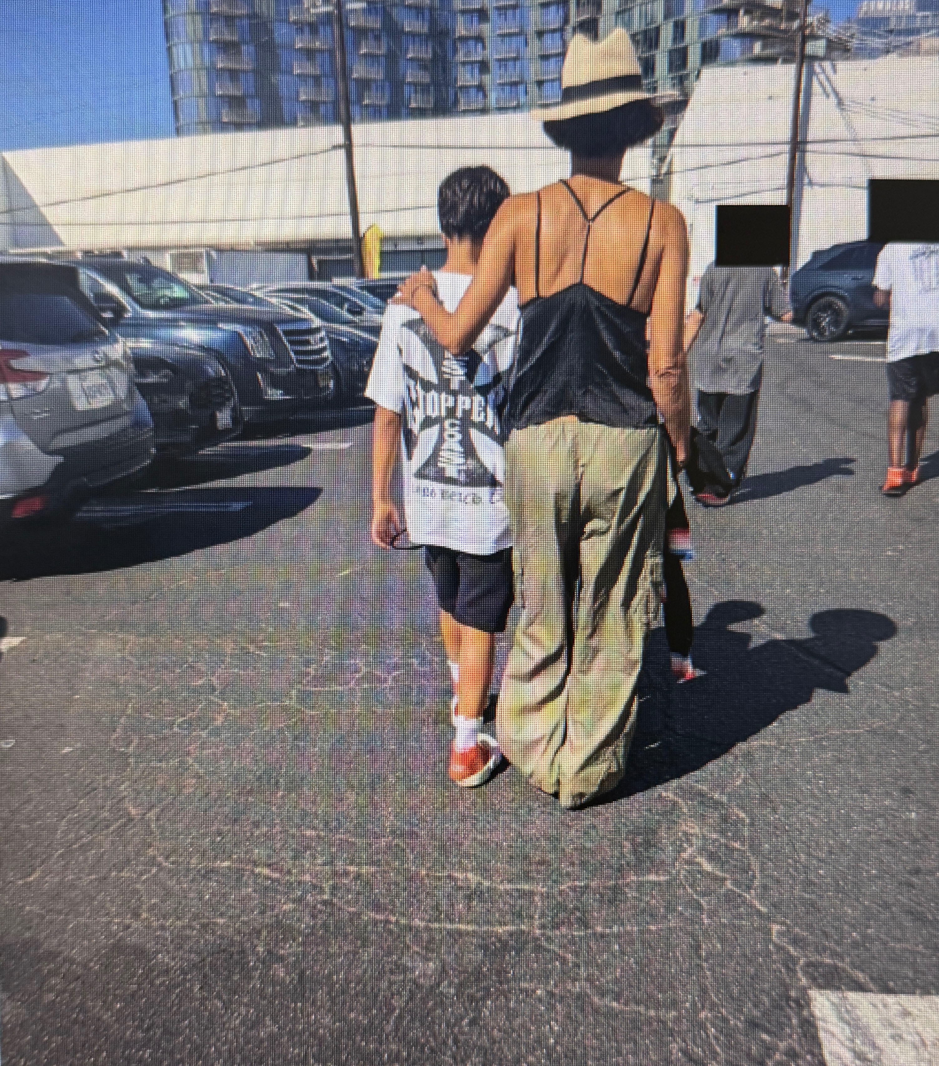 Halle Berry walking with her son Maceo in a parking lot.