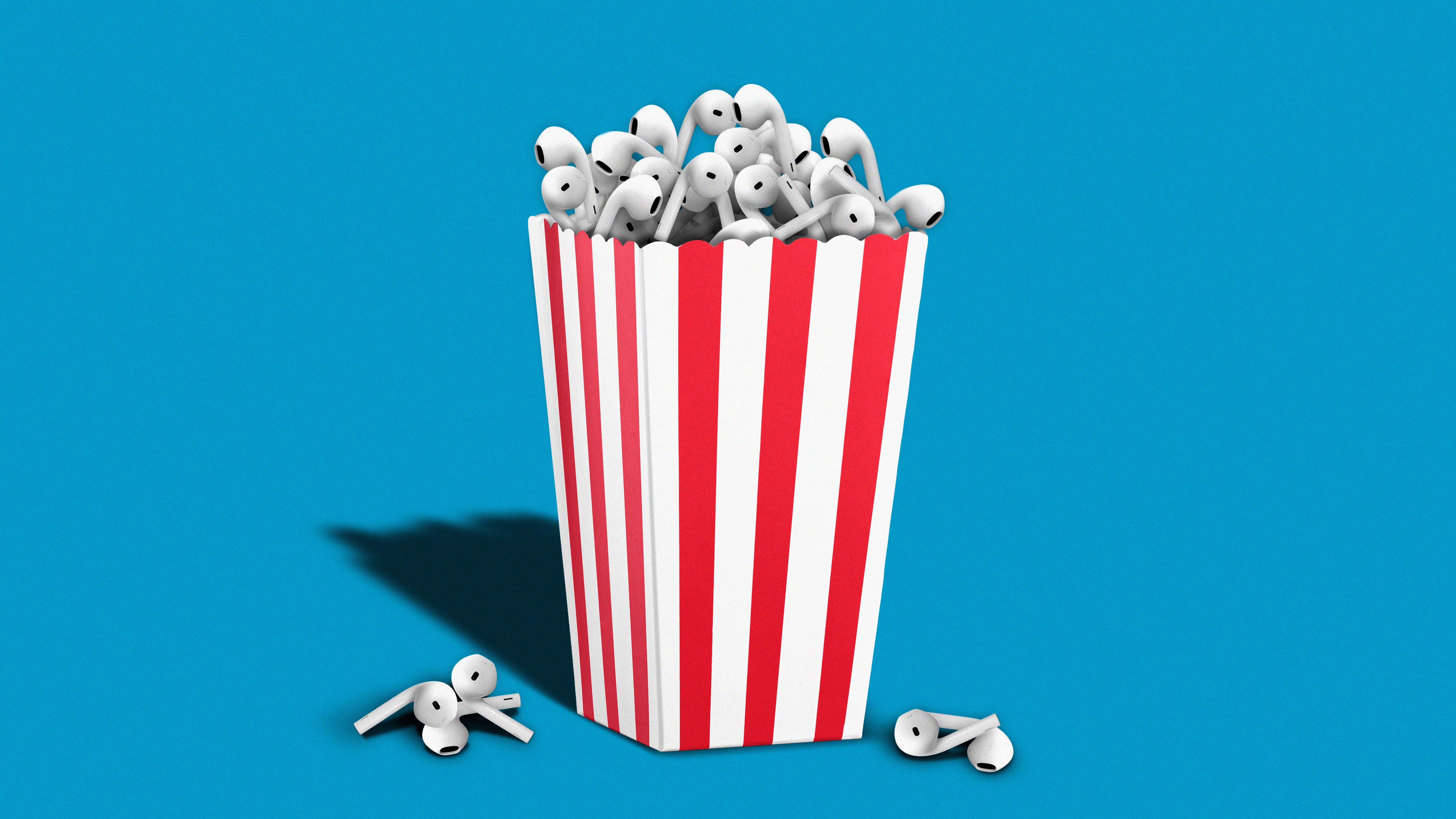 Airpods overflow from a popcorn bucket.