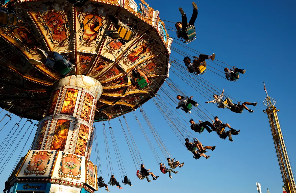 Fairgoers ride a swing ride at the Big Fresno Fair.