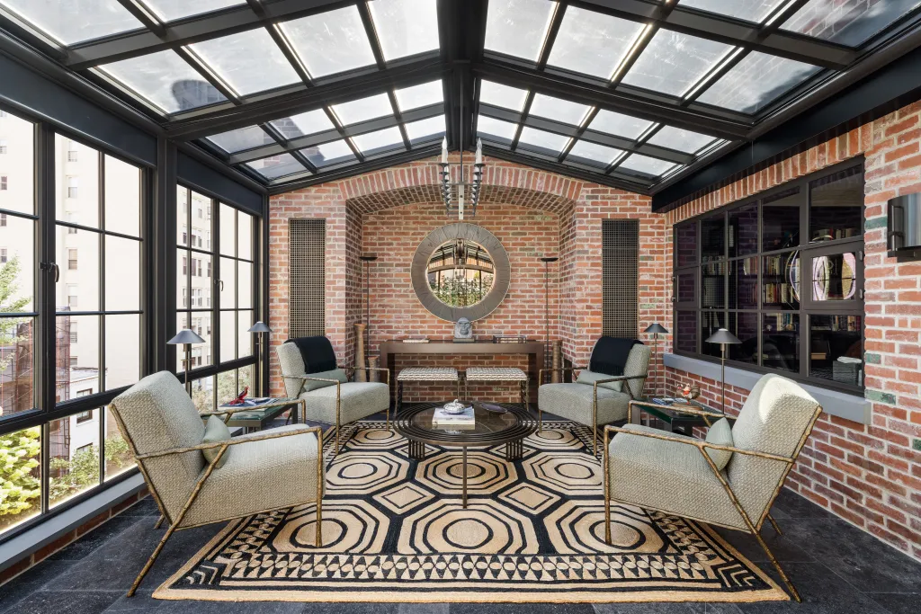 Other perks include two elevators, six wood-burning fireplaces, three terraces and a rare private curb cut leading to a garage that doubles as entertaining space.