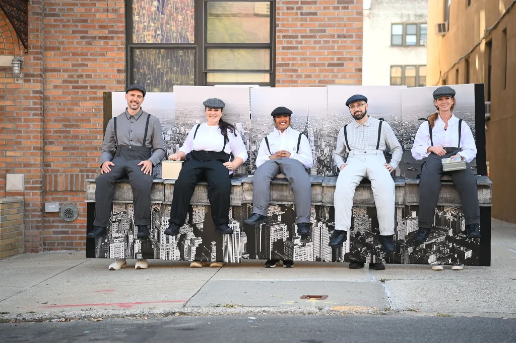 Five people prepare costumes to re-create the famous 1932 photograph 