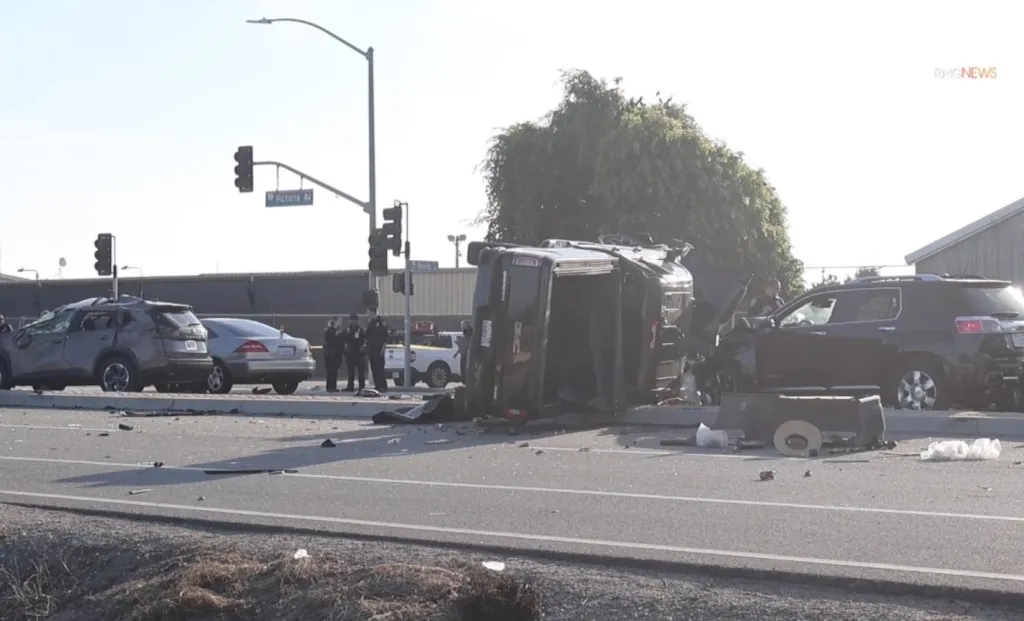 Scene of a severe seven-vehicle crash in Oxnard with heavily damaged cars and an SUV overturned on the road.