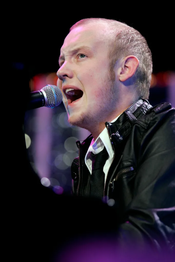 Isaac Slade performing in a concert.
