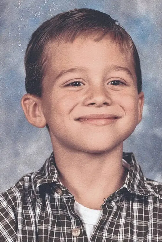 Portrait of Blake Dickus smiling in a plaid shirt.