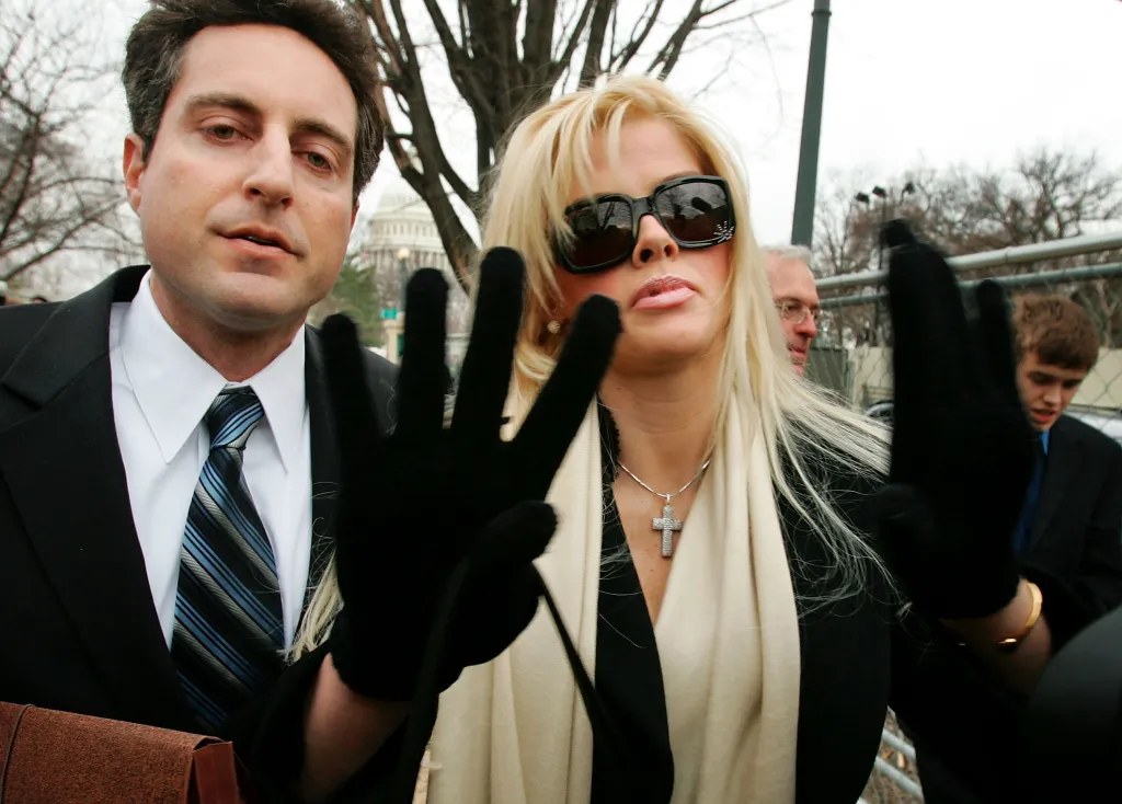 Former Playboy playmate Anna Nicole Smith , in a cream scarf and black jacket, arrives with her attorney, Howard K. Stern, in a black suit and blue striped tie, at the U.S. Supreme Court in Washington, D.C.