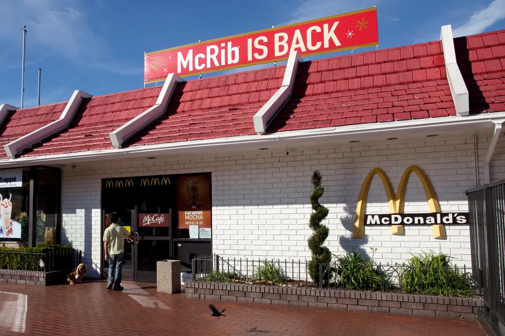 A McRib sign hanging on the roof of a McDonald's restaurant.