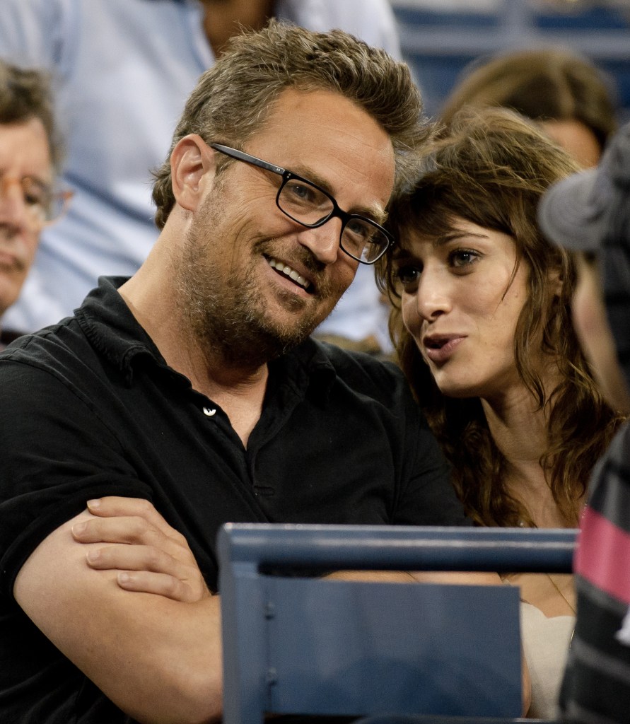 Matthew Perry and Lizzy Caplan attending the U.S. Open tennis championships.