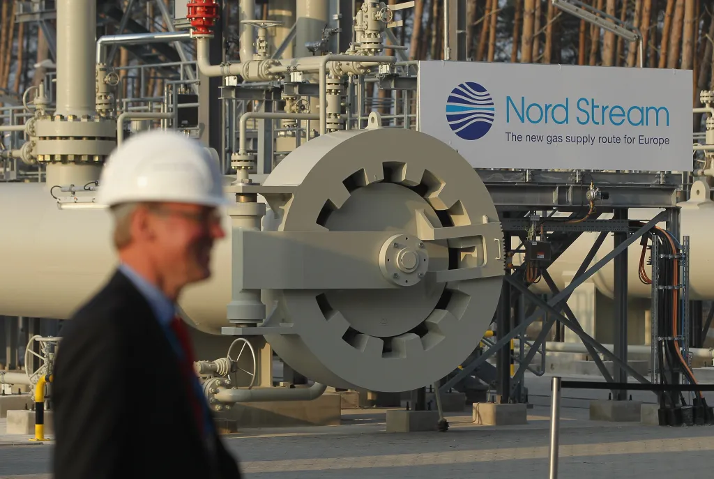 A man wearing a hard hat walks by the central facility where the Nord Stream Baltic Sea gas pipeline reaches western Europe following the pipeline's official inauguration in Lubmin, Germany, on Nov. 8, 2011.