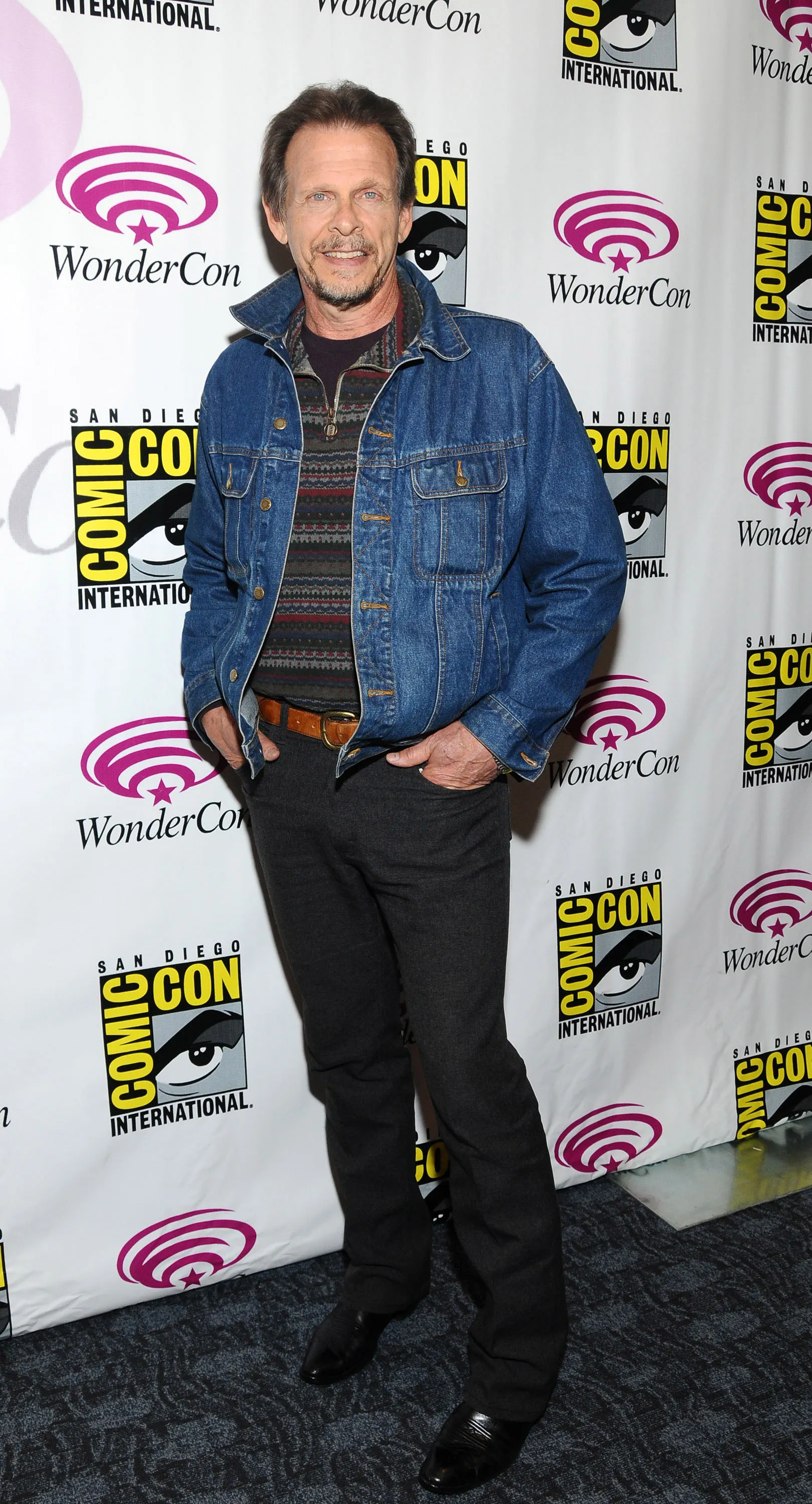 Marc Singer standing in front of a WonderCon backdrop.