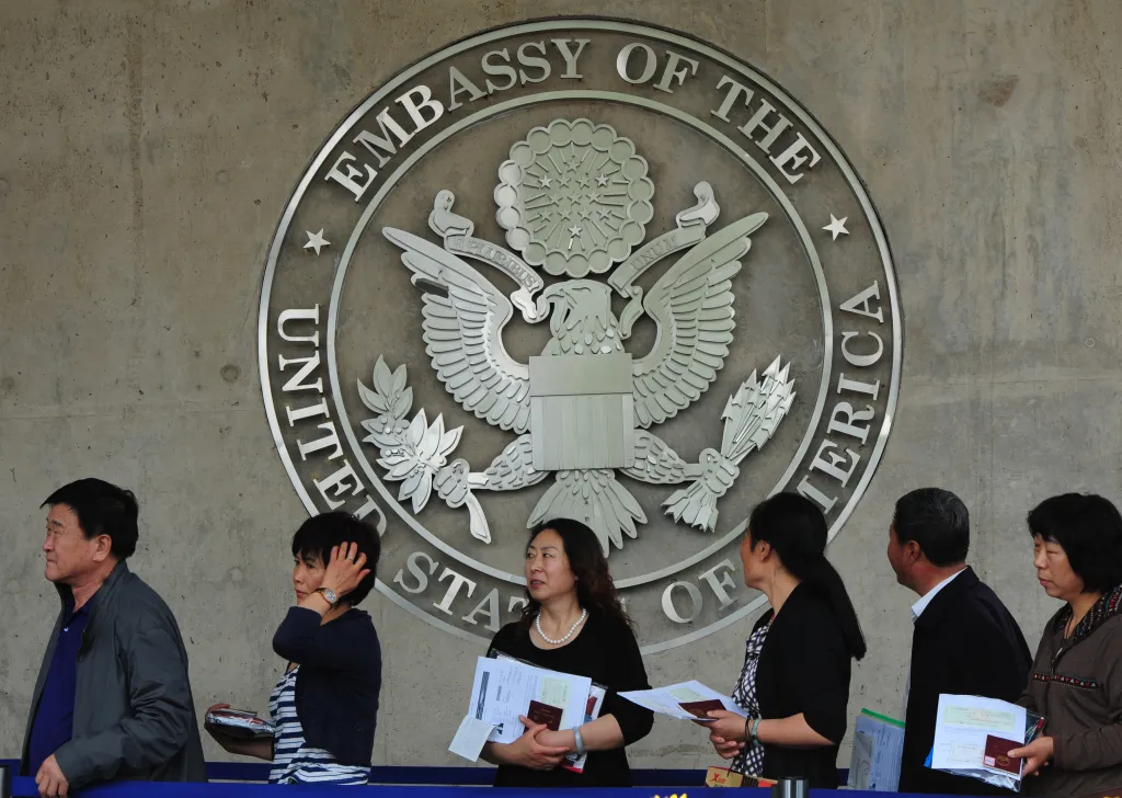 Chinese citizens wait to submit their visa applications at the US Embassy, where blind rights activist Chen Guangcheng is believed to be hiding, in Beijing.