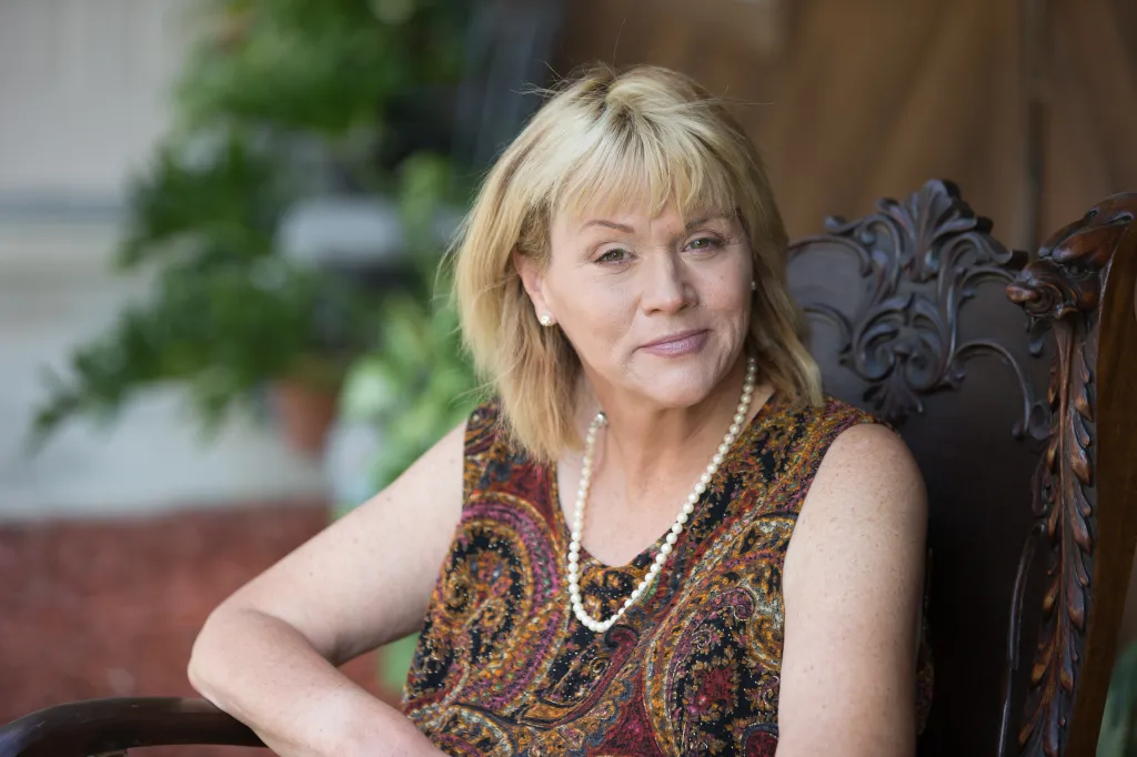 Samantha Markle sitting in a carved wooden chair outside her home in Ocala, Florida.