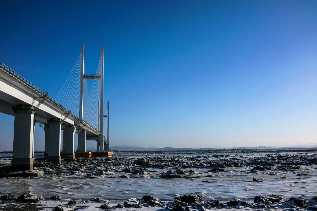 The bridge initially was expected to enter use in 2014 after China apparently completed construction of access roads, customs facilities and other related infrastructure on its side.