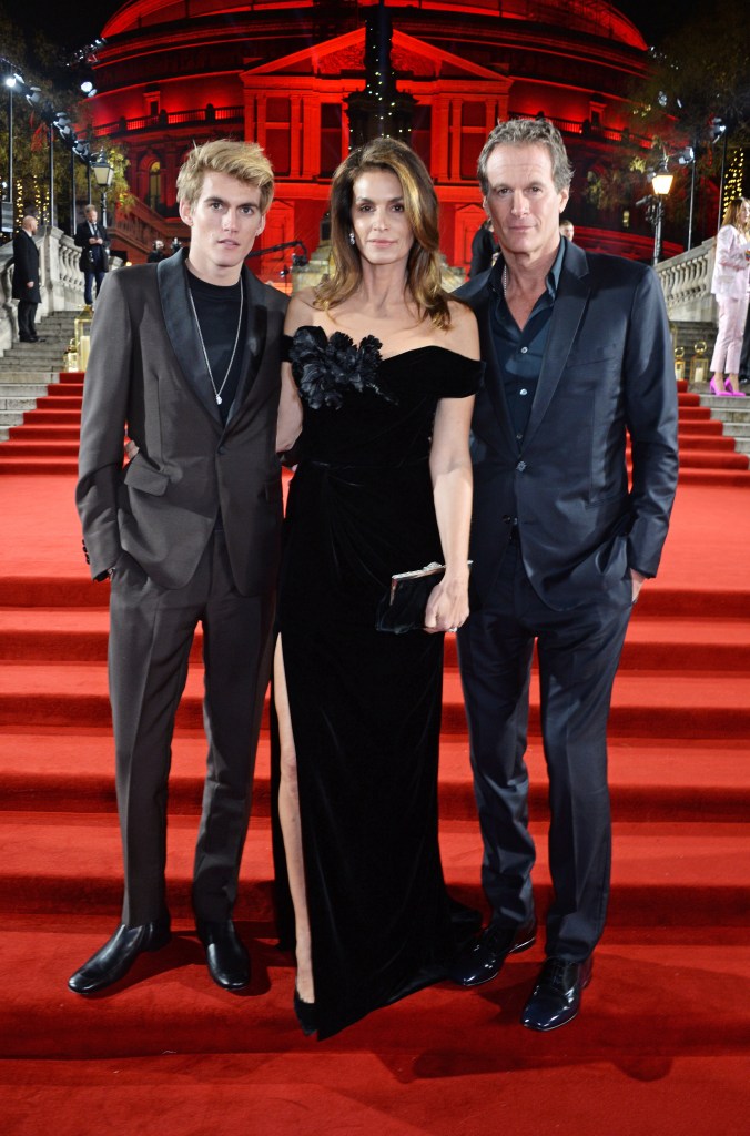 Presley Gerber, Cindy Crawford and Rande Gerber pose on a red carpet.