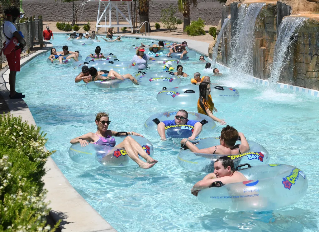 Guests float on the Lazy River in transparent inner tubes at Cowabunga Bay Water Park.