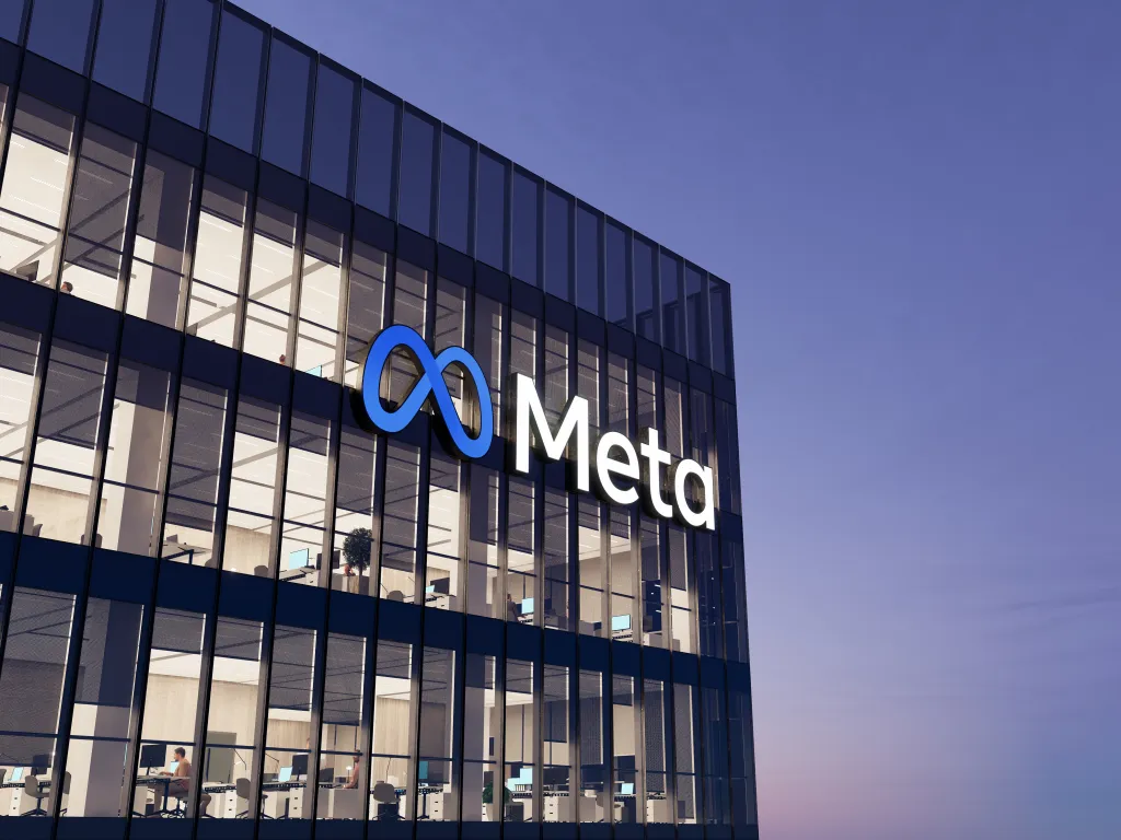 Illustration of the Meta logo on the glass exterior of a high-rise office building.
