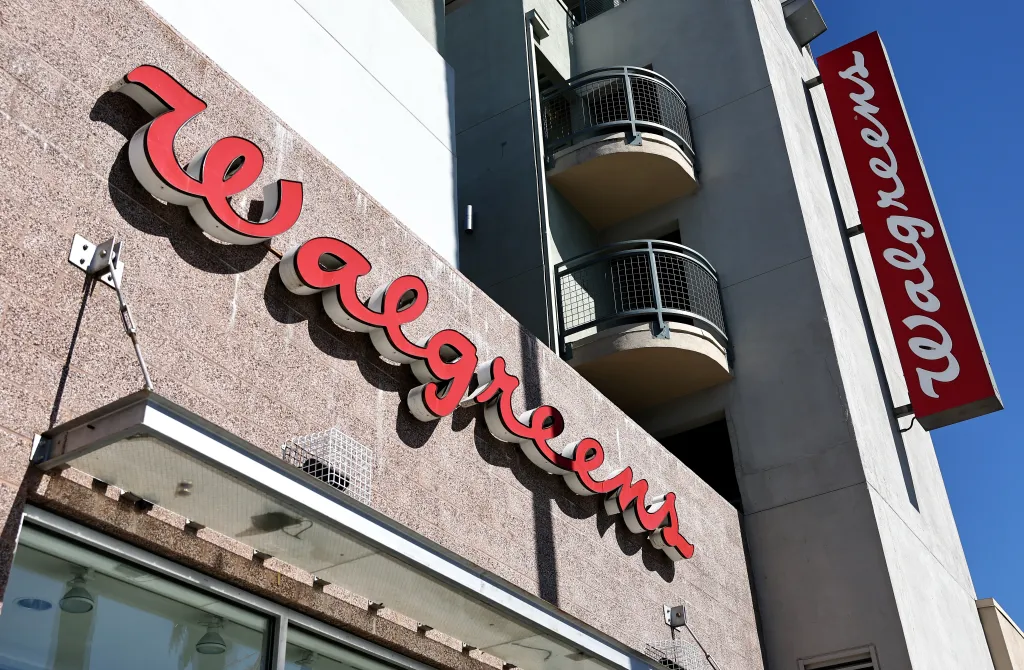 The Walgreens logo is displayed on the exterior of a Walgreens store.
