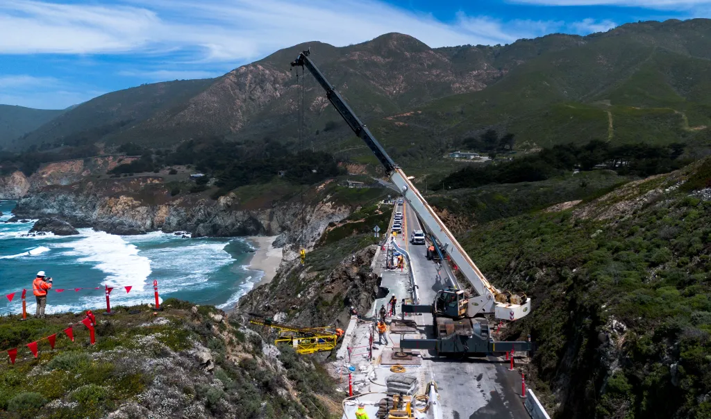 Crews and a crane stabilize the section of California Highway 1 that collapsed into the Pacific Ocean in Big Sur.