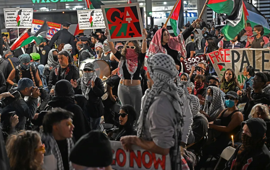 Counterprotesters supporting the Palestinian people demonstrate during a candlelight vigil for the victims of the Oct. 7 attacks in Israel, in Union Square, New York.