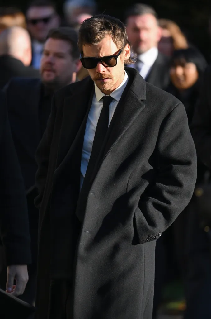 Harry Styles wearing a black coat and sunglasses at the funeral for Liam Payne.